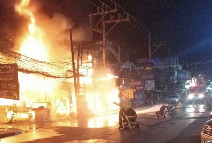 Firefighters combat a huge fire Friday night near Phuket’s Patong beach.