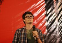Thanathorn Did Not Aid Anti-Coup Protesters: Rangsiman Rangsiman Rome speaks on a stage during a 2018 democracy rally.