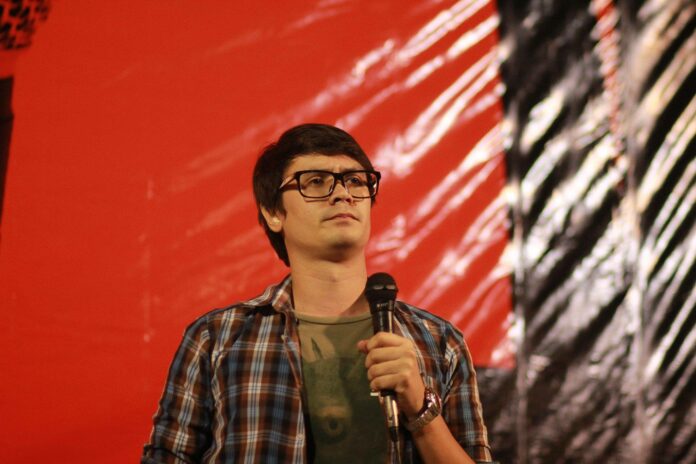 Rangsiman Rome speaks on a stage during a 2018 democracy rally. Rangsiman Rome speaks on a stage during a 2018 democracy rally.