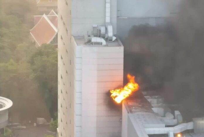 Fire and thick smoke is seen pluming out of a building in the CentralWorld shopping complex Wednesday evening.