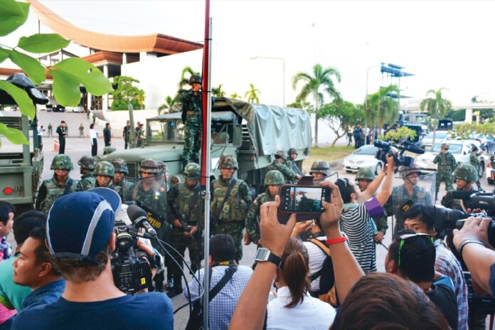 Soldiers confront reporters as the junta seized power on May 22, 2014.