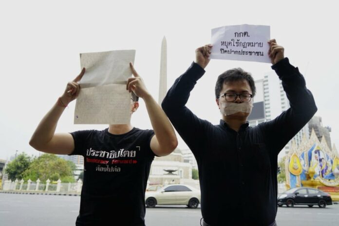 Lawyer and activist Arnon Nampa, right, leads a protest against the Election Commission April 7, 2019 at Bangkok’s Victory Monument. Photo: Thai Lawyers for Human Rights / Twitter