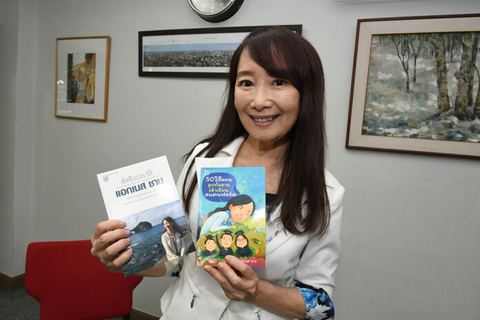Agnes Chan holds up Thai versions of her books. Agnes Chan holds up Thai versions of her books.