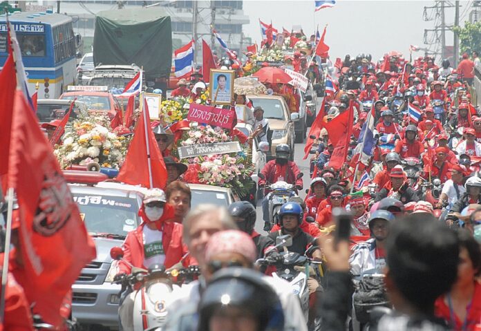 Redshirt protesters on April 12, 2010, parade portraits of those killed in the military crackdown two days earlier on the streets of Bangkok.