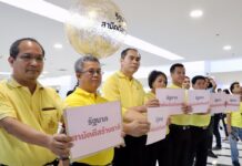 7 New Parties Propose Unity Govt, Senate Selection by King Representatives of seven political parties hold signs proposing a unity government on Monday at a news conference in Bangkok.