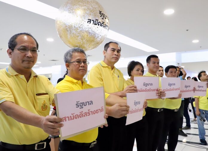Representatives of seven political parties hold signs proposing a unity government on Monday at a news conference in Bangkok.