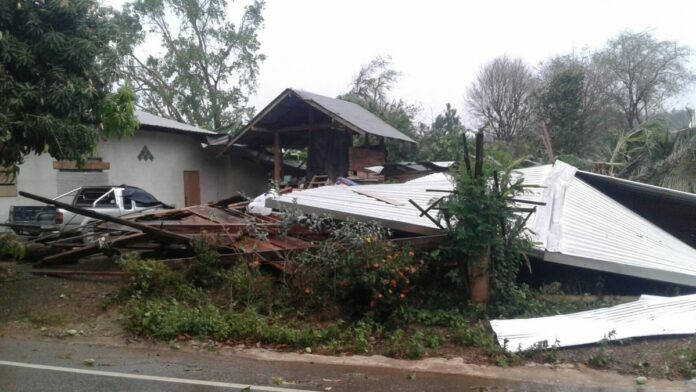 A house in the northern province of Nan is seen collapsed to the ground on Tuesday following a powerful storm.