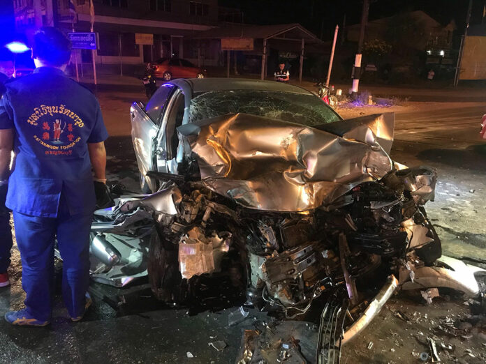 A rescue worker stands near the scene of a fatal car accident early Thursday morning in Kanchanaburi province.