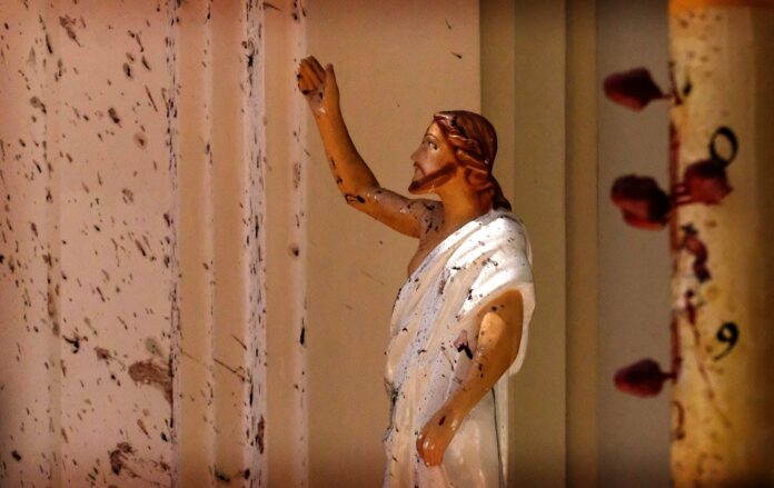 Blood stains are seen on the wall and on a Jesus Christ statue at the St. Sebastian's Church after blast in Negombo, north of Colombo, Sri Lanka.