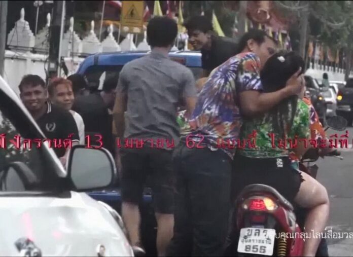 A screencap of a video showing a man assaulting a woman in Ubon Ratchathani