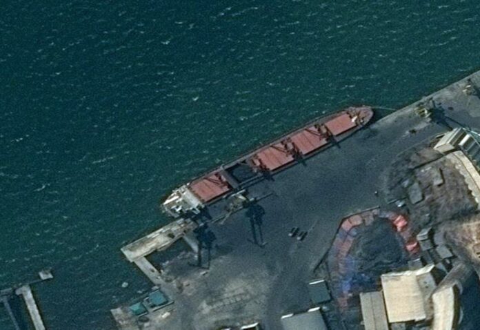 This satellite image provided by the Department of Justice shows what the DoJ says is the North Korean cargo ship Wise Honest docked at a unknown port. (Department of Justice via AP)