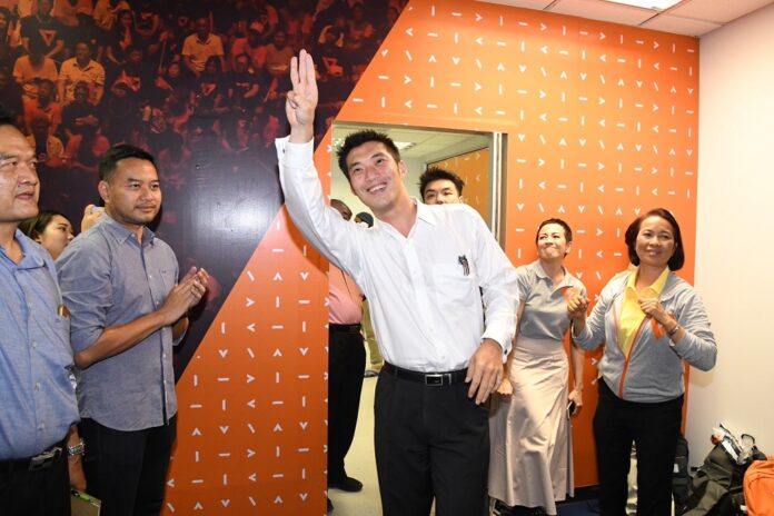 Future Forward Party chairman Thanathorn Juangroongruangkit flashes an anti-junta “three finger salute” at a news conference on May 23, 2019.