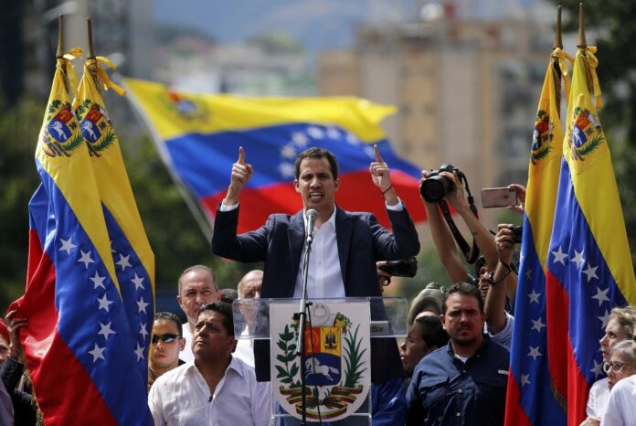 Juan Guaido, head of Venezuela's opposition-run congress, declares himself interim president of the nation until elections can be held during a rally demanding President Nicolas Maduro's resignation in Caracas, Venezuela, Wednesday, Jan. 23, 2019. (AP Photo/Fernando Llano)