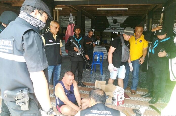 Security officers surround Police Capt. Chainarong Oiphuthon at his home on May 7, 2019.