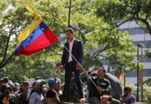 Key Events Leading Toward Uprising in Venezuela Venezuela's opposition leader and self-proclaimed President Juan Guaido stands before supporters as he addresses them outside La Carlota military air base in Caracas, Venezuela, Tuesday, April 30, 2019. Guaidó, accompanied by civilian protesters and a small contingent of heavily armed troops, called Tuesday for the military to rise up and oust socialist leader Nicolas Maduro. Photo: Fernando Llano / AP