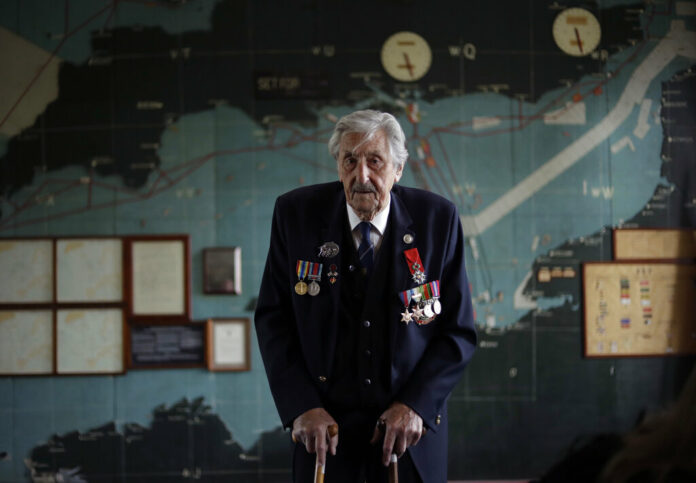 British D-Day veteran Leonard 'Ted' Emmings, who was a naval Coxswain serving on a small landing craft which landed 36 Canadians on Juno beach in France, poses for photographs backdropped by the map used to plan the Normandy D-Day landings at Southwick House near Portsmouth, England, May 9, 2019. Southwick House was the forward headquarters of the allied forces preparing for the invasion of Normandy in 1944, the nerve center of D-Day. Photo: Matt Dunham