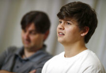 Colorado Teen Called Mom While Subduing School Shooter Joshua Jones, front, who was wounded while trying to stop a gunman involved in the attack on the STEM School Highlands Ranch last week, speaks during a news conference as his father, David, listens Tuesday, May 14, 2019, in Littleton, Colo. Photo: David Zalubowski / AP