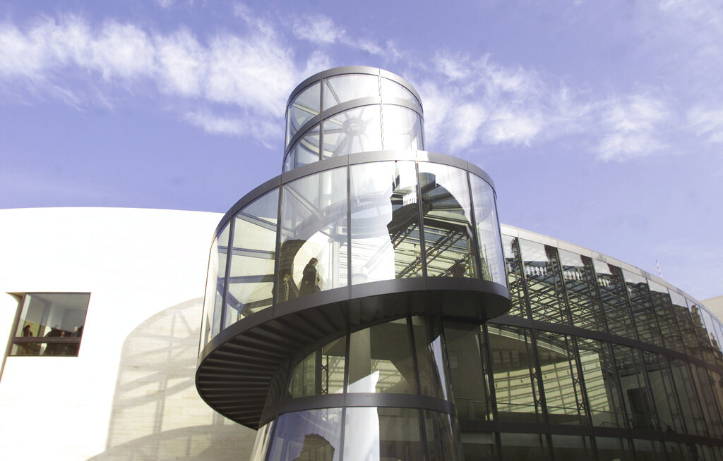 In this Friday, Feb. 28, 2003, file photo, a woman walks up the spiral stairway of the new section of the German Historic Museum in Berlin. Photo: Franka Bruns / AP