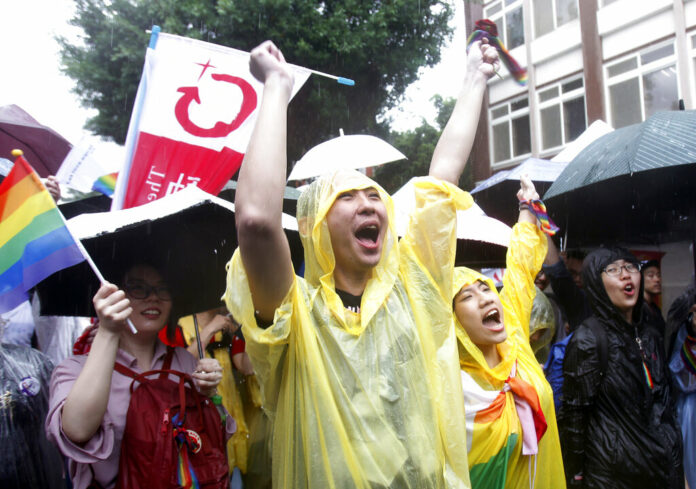 Same-sex marriage supporters cheer outside the Legislative Yuan in Taipei, Taiwan, Friday, May 17, 2019 after Taiwan's legislature has passed a law allowing same-sex marriage in a first for Asia.and child custody. Photo: Chiang Ying-ying / AP