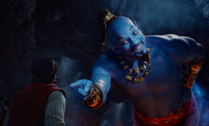This image released by Disney shows Mena Massoud as Aladdin, left, and Will Smith as Genie in Disney's live-action adaptation of the 1992 animated classic 
