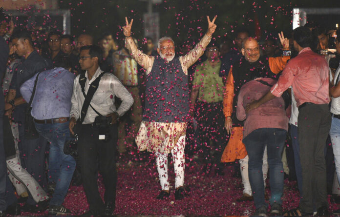 Indian Prime Minister Narendra Modi and Bharatiya Janata Party (BJP) President Amit Shah greet supporters on arrival at the party headquarters in New Delhi, India, Thursday, May 23, 2019. Photo: AP