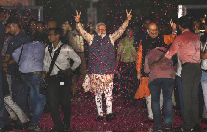 Indian Prime Minister Narendra Modi and Bharatiya Janata Party (BJP) President Amit Shah greet supporters on arrival at the party headquarters in New Delhi, India, Thursday, May 23, 2019. Photo: AP Indian Prime Minister Narendra Modi and Bharatiya Janata Party (BJP) President Amit Shah greet supporters on arrival at the party headquarters in New Delhi, India, Thursday, May 23, 2019. Photo: AP