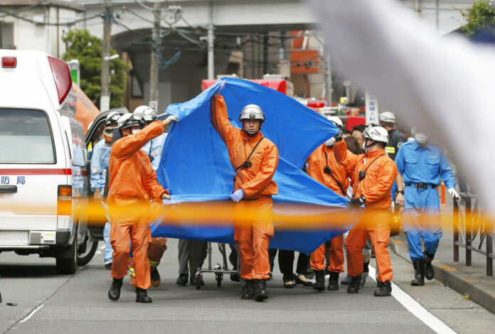 Rescuers work at the scene of an attack in Kawasaki, near Tokyo Tuesday, May 28, 2019. A man wielding a knife attacked commuters waiting at a bus stop just outside Tokyo during Tuesday morning's rush hour, Japanese authorities and media said. Photo: Kyodo News via AP