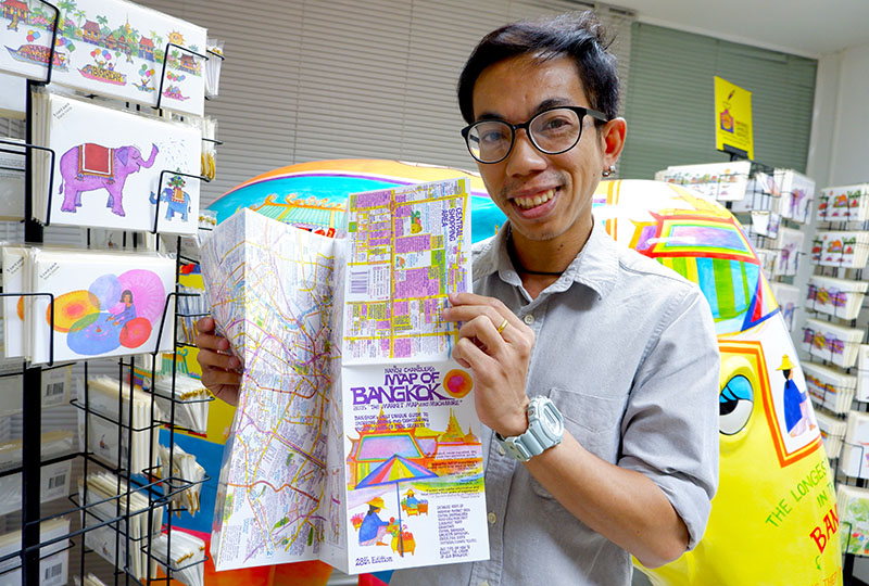 Roengsak Chankasem holds the 28th edition of Nancy Chandler's Map of Bangkok.