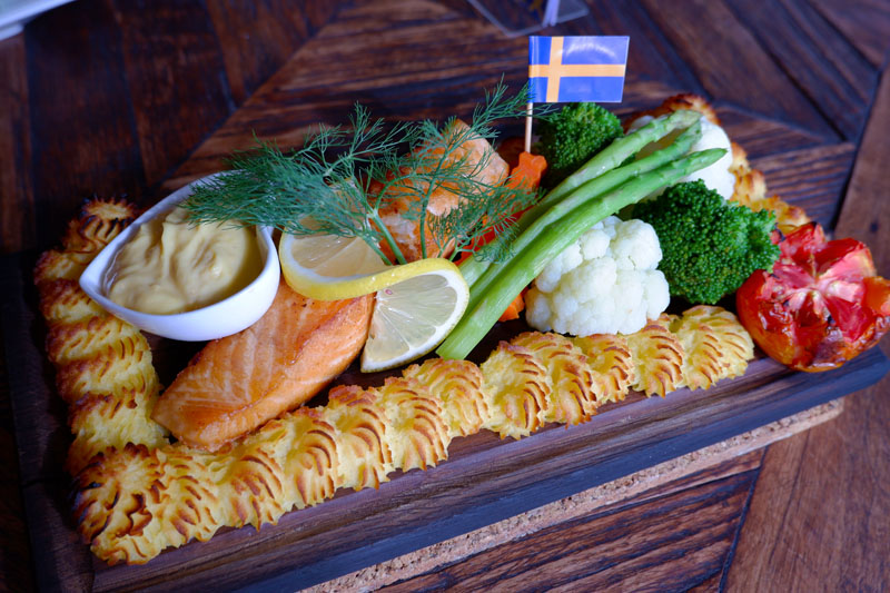 Oven-baked salmon on a wooden platter (429 baht).