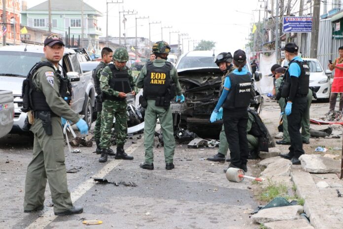 Security officers collect evidence at the scene of a bomb attack in Pattani province on May 27, 2019.