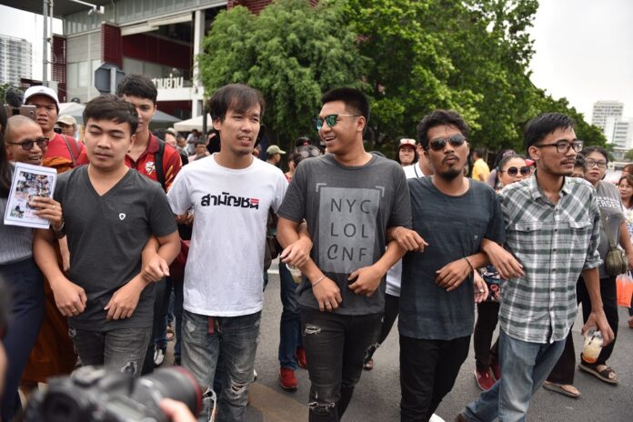The 13 activists outside the Pathumwan police station on May 22, 2019.