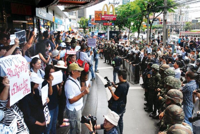 Soldiers face off with anti-coup protesters in Bangkok on May 24, 2014.