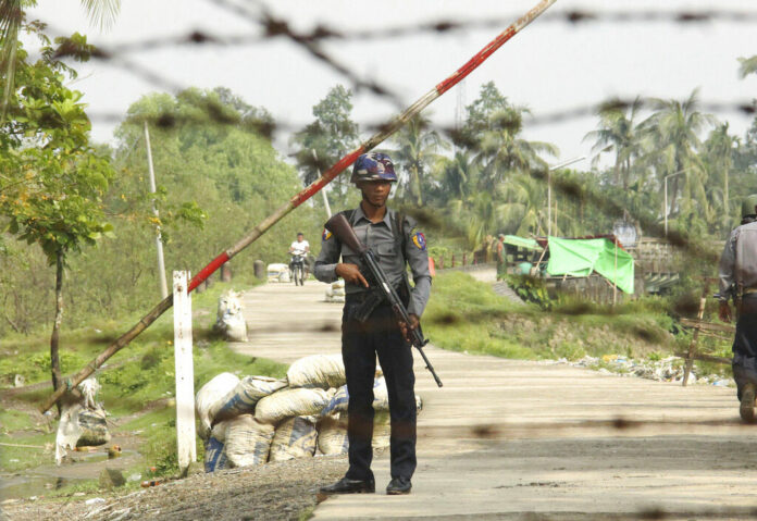 In this Sept. 6, 2017, file photo, a Myanmar police officer stands guard at a checkpoint in Shwe Zar village in the northern Rakhine state of Myanmar. Amnesty International, in a report issued Wednesday, May 29, 2019, says it has found new evidence of war crimes and human rights violations in Rakhine State, where the armed forces two years ago carried out a brutal counterinsurgency campaign that drove more than 700,000 members of the Muslim Rohingya minority to flee across the border to Bangladesh. Photo: AP