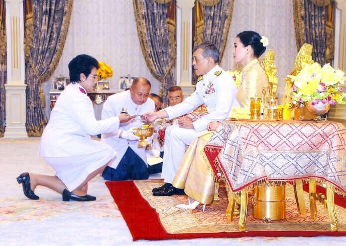King Vajiralongkorn and Queen Suthida hand out the donations on May 8, 2019.