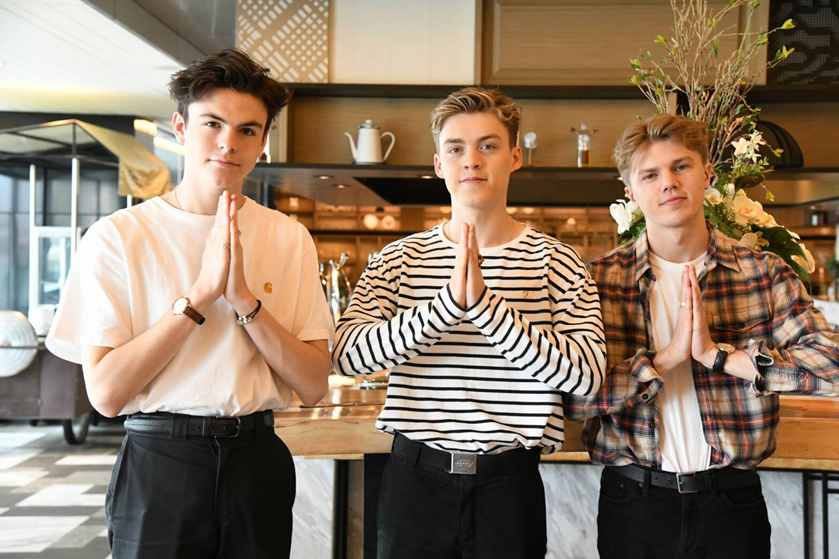 Blake Richardson, Reece Bibby, and George Smith of New Hope Club doing Thai wais.