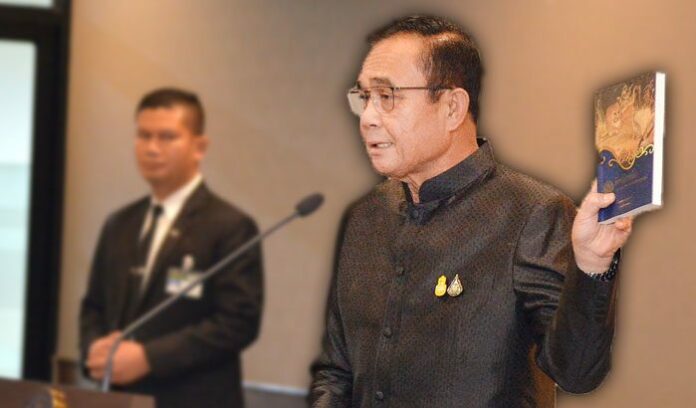 Gen. Prayuth Chan-ocha holds up a copy of “Aesop’s Fables” on June 11, 2019.