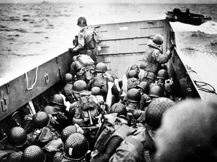 Troops crouch inside a LCVP landing craft, just before landing on Omaha Beach on D-Day, 6 June 1944.