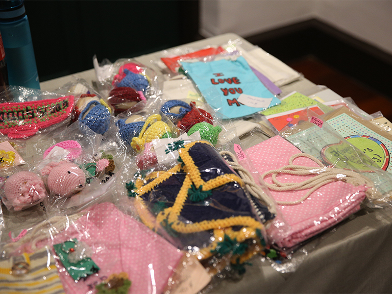 Knit products and postcards made by refugees.