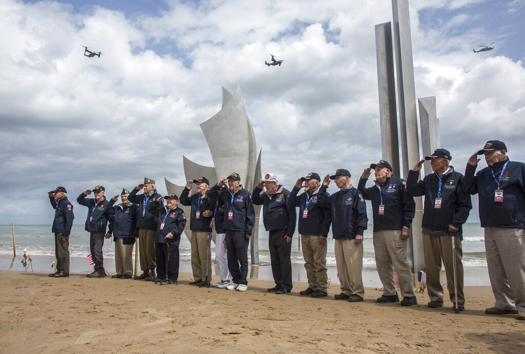 World War II veterans from the United States salute as they pose in front of Les Braves monument at Omaha Beach in Saint-Laurent-sur-Mer, Normandy, France, Monday, June 3, 2019. France is preparing to mark the 75th anniversary of the D-Day invasion which took place on June 6, 1944. Photo: Rafael Yaghobzadeh / AP