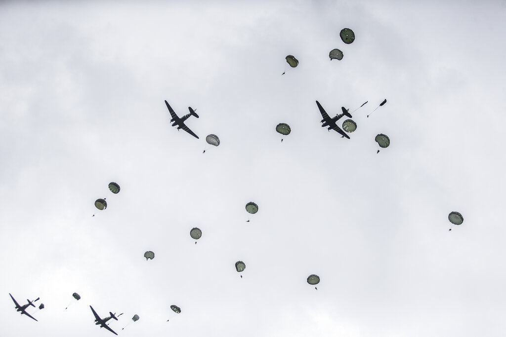 Parachutists jump from C-47 transport planes in Carentan, Normandy, France, Wednesday, June 5, 2019. Approximately 200 parachutists participated in the jump over Normandy on Wednesday, replicating a jump made by U.S. soldiers on June 6, 1944 as a prelude to the seaborne invasions on D-Day. Photo: Rafael Yaghobzadeh / AP