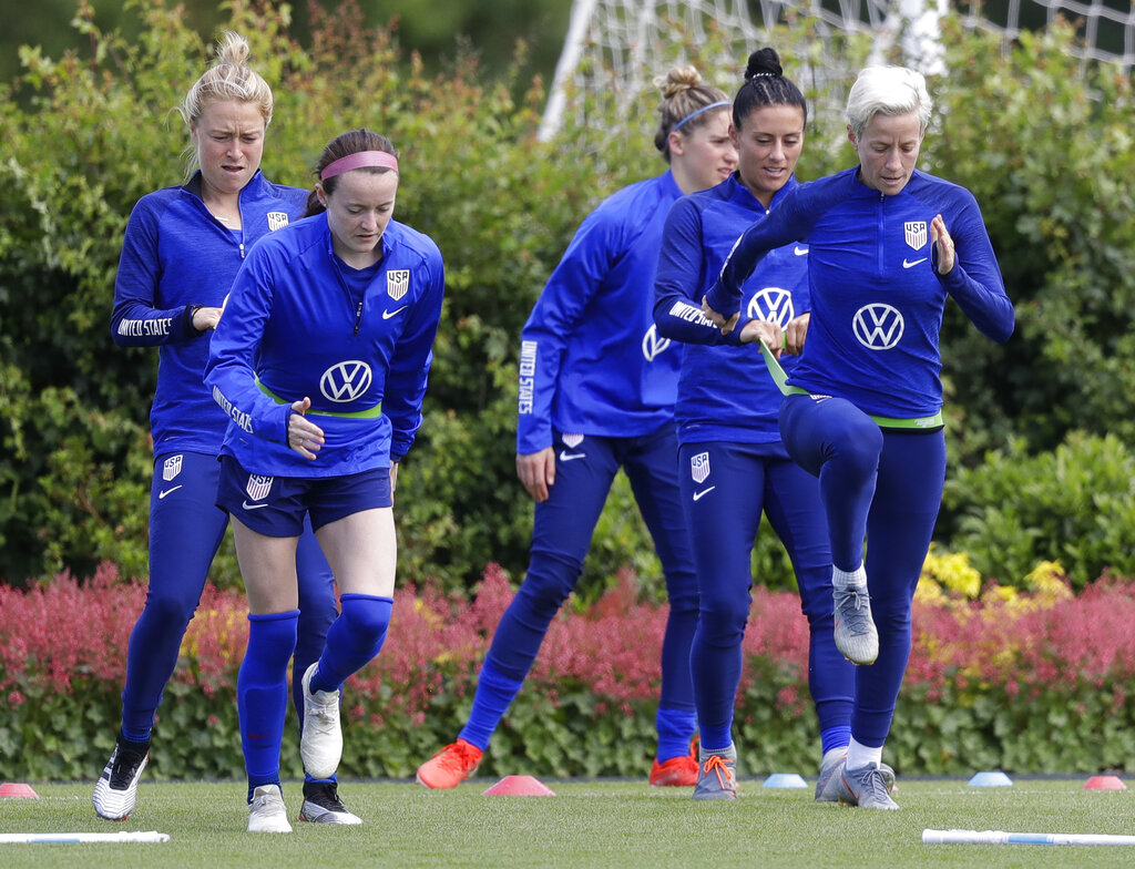 US player Megan Rapinoe, front right, stretches with Ali Krieger and other team members during a US womens soccer team training session at the Tottenham Hotspur training centre in London, Thursday, June 6, 2019. The Women's World Cup starts in France on June 7. Photo: Kirsty Wigglesworth AP