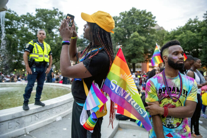 People watch the conclusion of the Capitol Pride Parade at Dupont Circle in Washington, Saturday, June 8, 2019. Photo: Andrew Harnik / AP