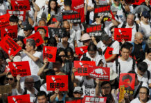 Massive Extradition Bill Protest Fills Hong Kong Streets Protesters hold placards march in a rally against the proposed amendments to extradition law in Hong Kong, Sunday, June 9, 2019. The amendments have been widely criticized as eroding the semi-autonomous Chinese territory's judicial independence by making it easier to send criminal suspects to mainland China, where they could face vague national security charges and unfair trials. Photo: Kin Cheung / AP