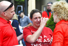 Southern Baptist Leader Bemoans Abuse Crisis, Vows Action Jules Woodson, center, of Colorado Springs, Colo., is comforted by her boyfriend Ben Smith, left, and Christa Brown while demonstrating outside the Southern Baptist Convention's annual meeting Tuesday, June 11, 2019, in Birmingham, Ala. First-time attendee Woodson spoke through tears as she described being abused sexually by a Southern Baptist minister. Photo: Julie Bennett / AP