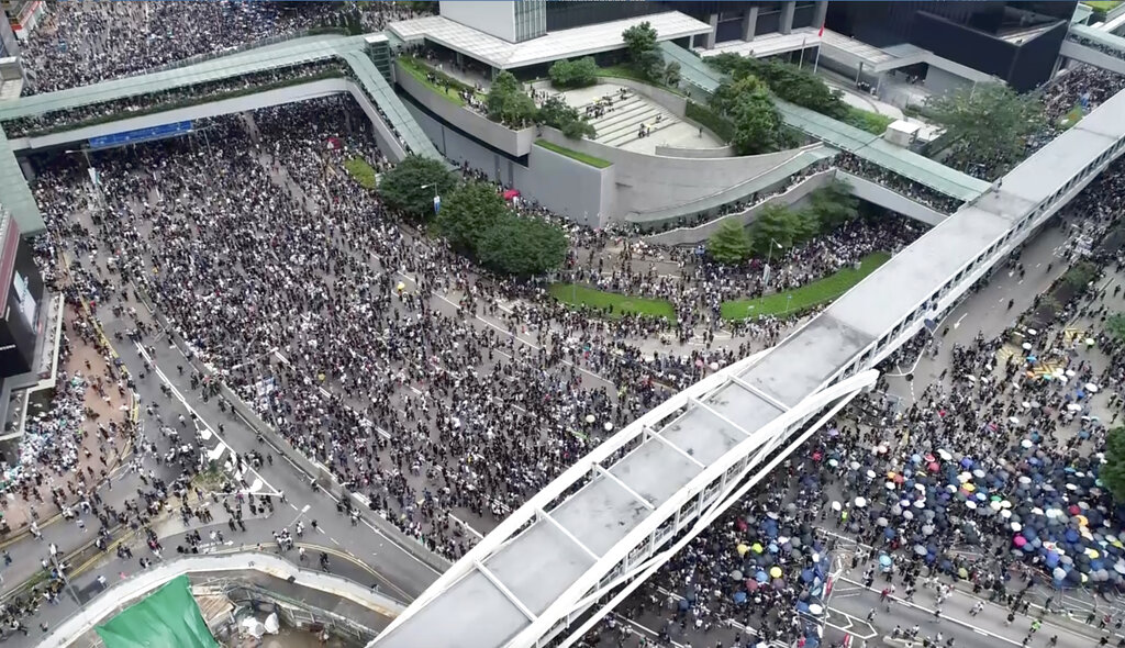 In this image made from aerial video, protesters gather in the streets outside the Legislative Council in Hong Kong, Wednesday, June 12, 2019. Thousands of protesters have blocked access to Hong Kong's legislature and government headquarters in a bid to block debate on a highly controversial extradition bill that would allow accused people to be sent to China for trial. Photo: Apple Daily via AP