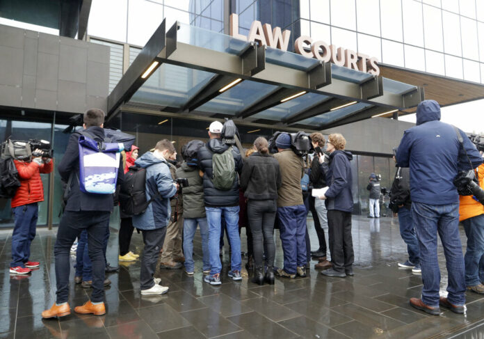 The media interview a mosque shooting victim outside the Christchurch District Court in Christchurch, New Zealand, Friday, June 14, 2019. Brenton Tarrant, the man accused of killing 51 people at two Christchurch mosques on March 15, 2019, pleaded not guilty to all the charges filed against him Friday. Photo: Mark Baker / AP