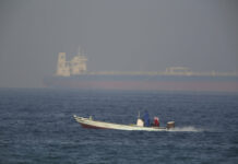 Tensions Rise as Iran Speeds up Enrichment, US Sends Troops A fishing boat speeds past an oil tanker in the distance in Fujairah, United Arab Emirates, Saturday, June 15, 2019. The Kokuka Courageous, one of two oil tankers targeted in an apparent attack in the Gulf of Oman, was brought to the United Arab Emirates' eastern coast Saturday. Photo: Jon Gambrell / AP