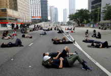 Hong Kong Police Begin to Clear Streets of Protesters Protesters who camped out overnight take a rest along a main road near the Legislative Council after continuing protest against the unpopular extradition bill in Hong Kong, Monday, June 17, 2019. Hong Kong police and protesters faced off Monday as authorities began trying to clear the streets of a few hundred who remained near the city government headquarters after massive demonstrations that stretched deep into the night before. Photo: Vincent Yu / AP