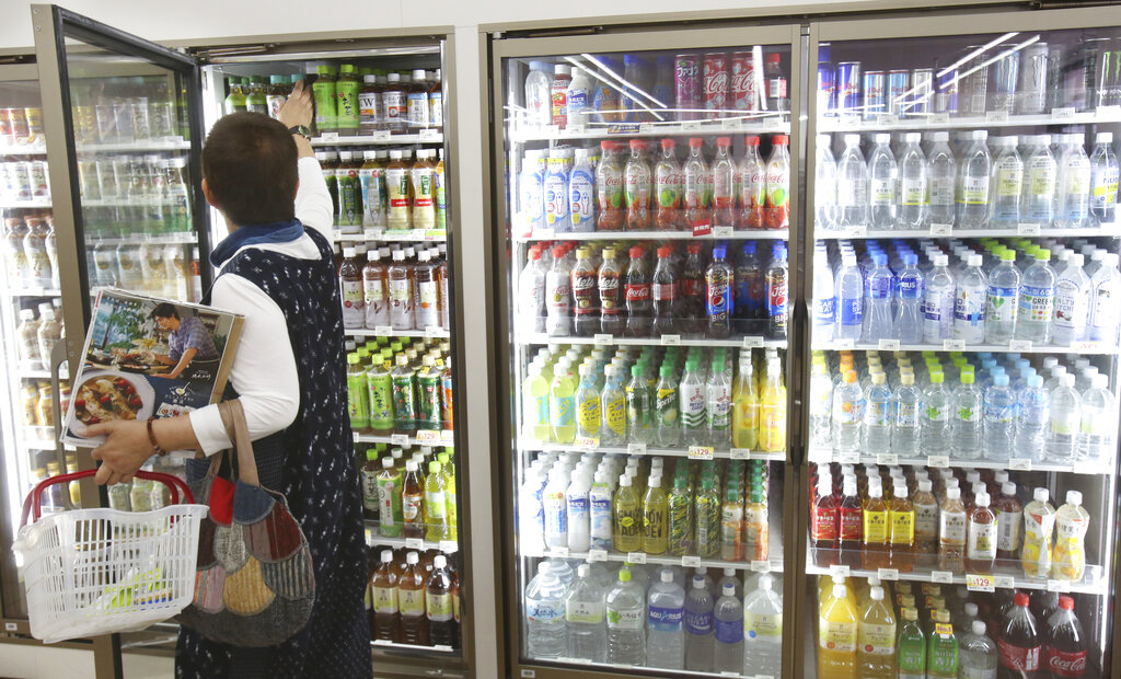 In this June 17, 2019, photo, plastic-bottled soft drinks are displayed in fridges at a Seven-Eleven store in Yokohama, near Tokyo. Photo: Koji Sasahara / AP