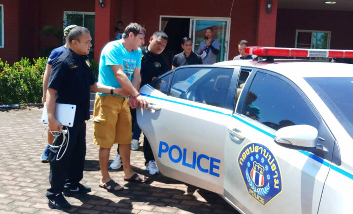 In this June 15, 2019, photo released by Crime Suppression Division, Italian Francesco Galdeli, center, is detained by Thai police officers at a house in Chonburi. Photo: Crime Suppression Division of Thailand via AP